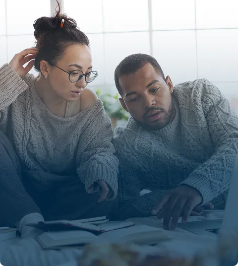 A couple looking stressed while looking at documents